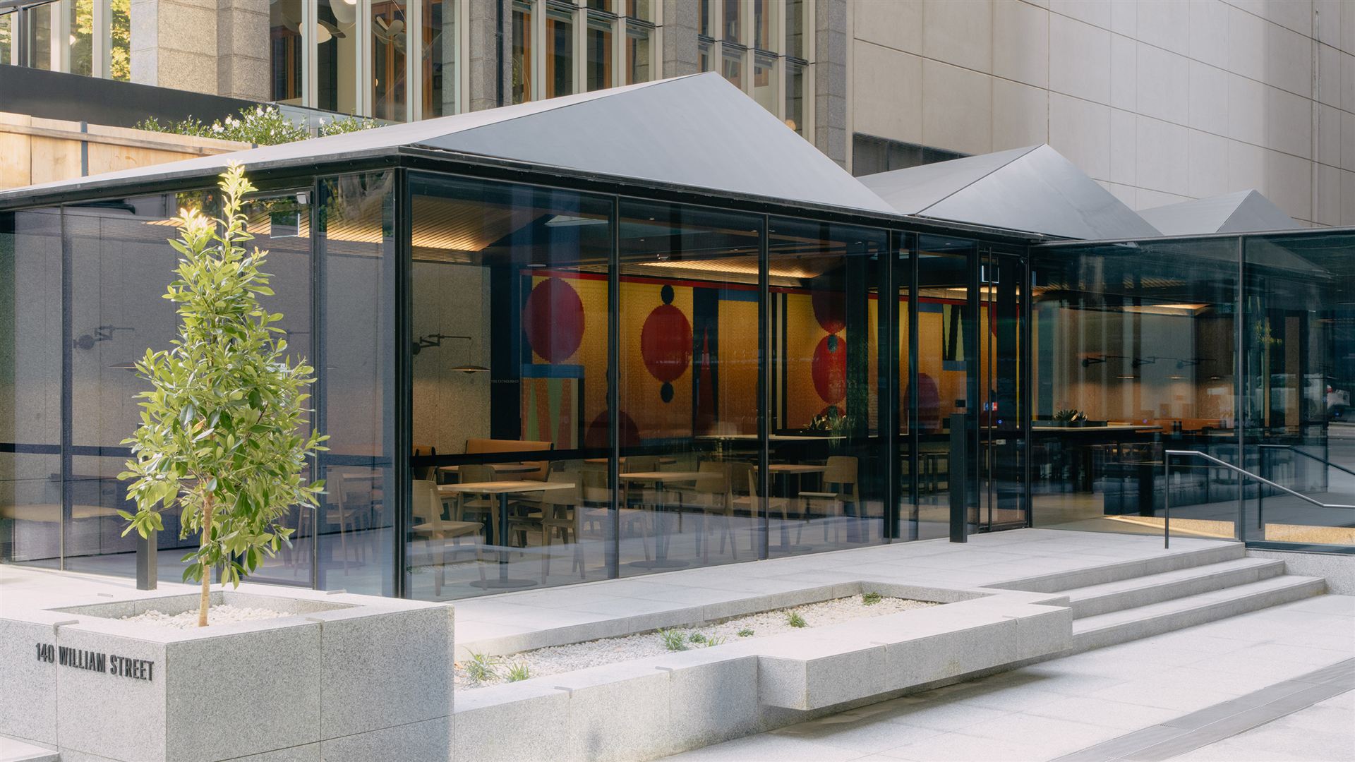 The glass cafe pavilion at the 140 William Street forecourt