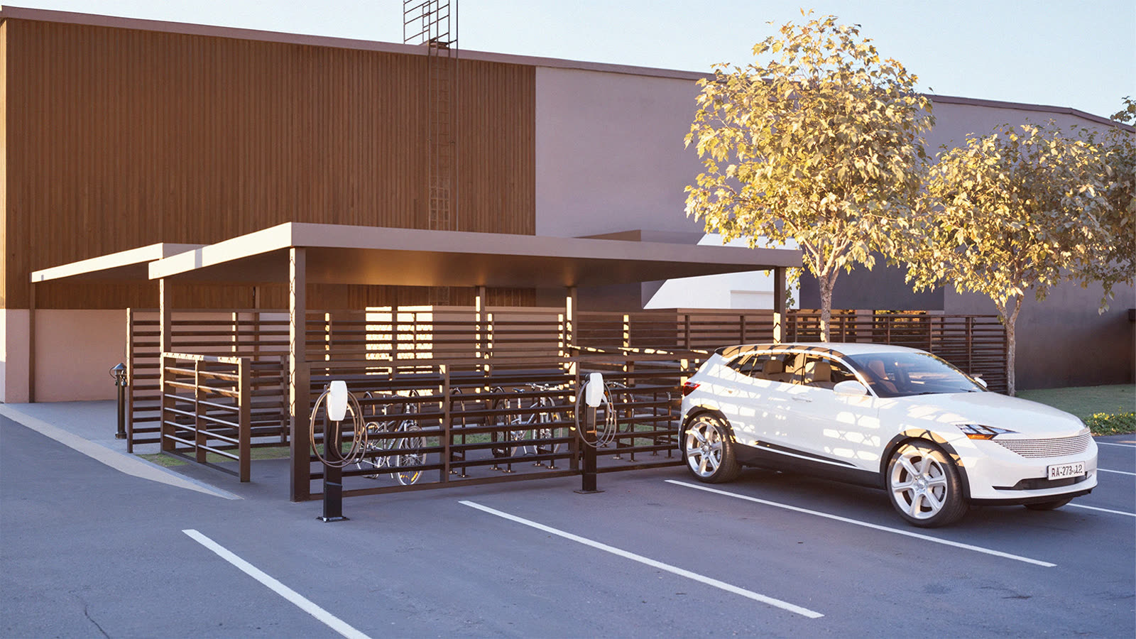 Covered bike store and EV charging bays against the timber-clad wall