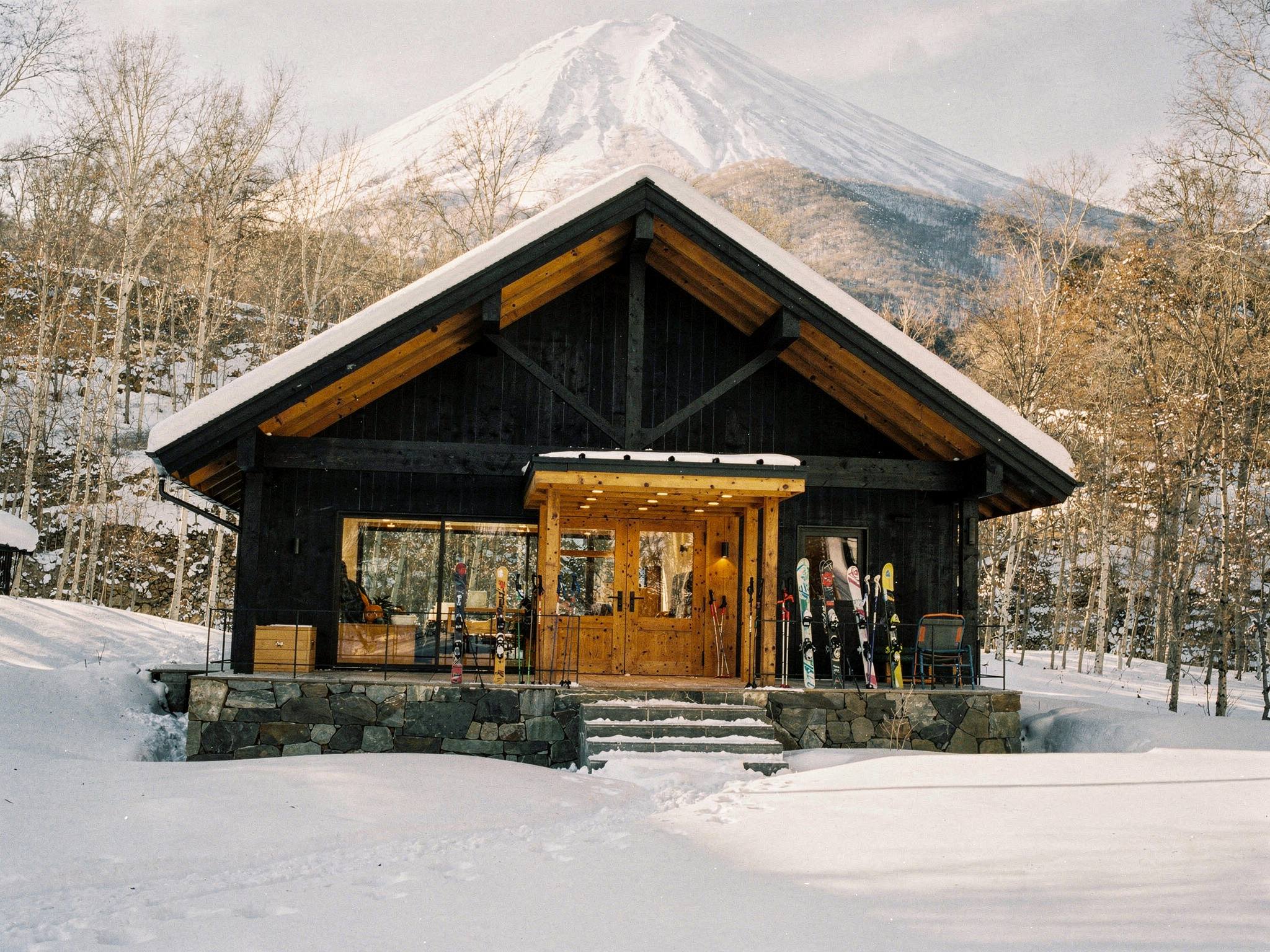 Skis racked at the glulam lodge entry on a bright winter day