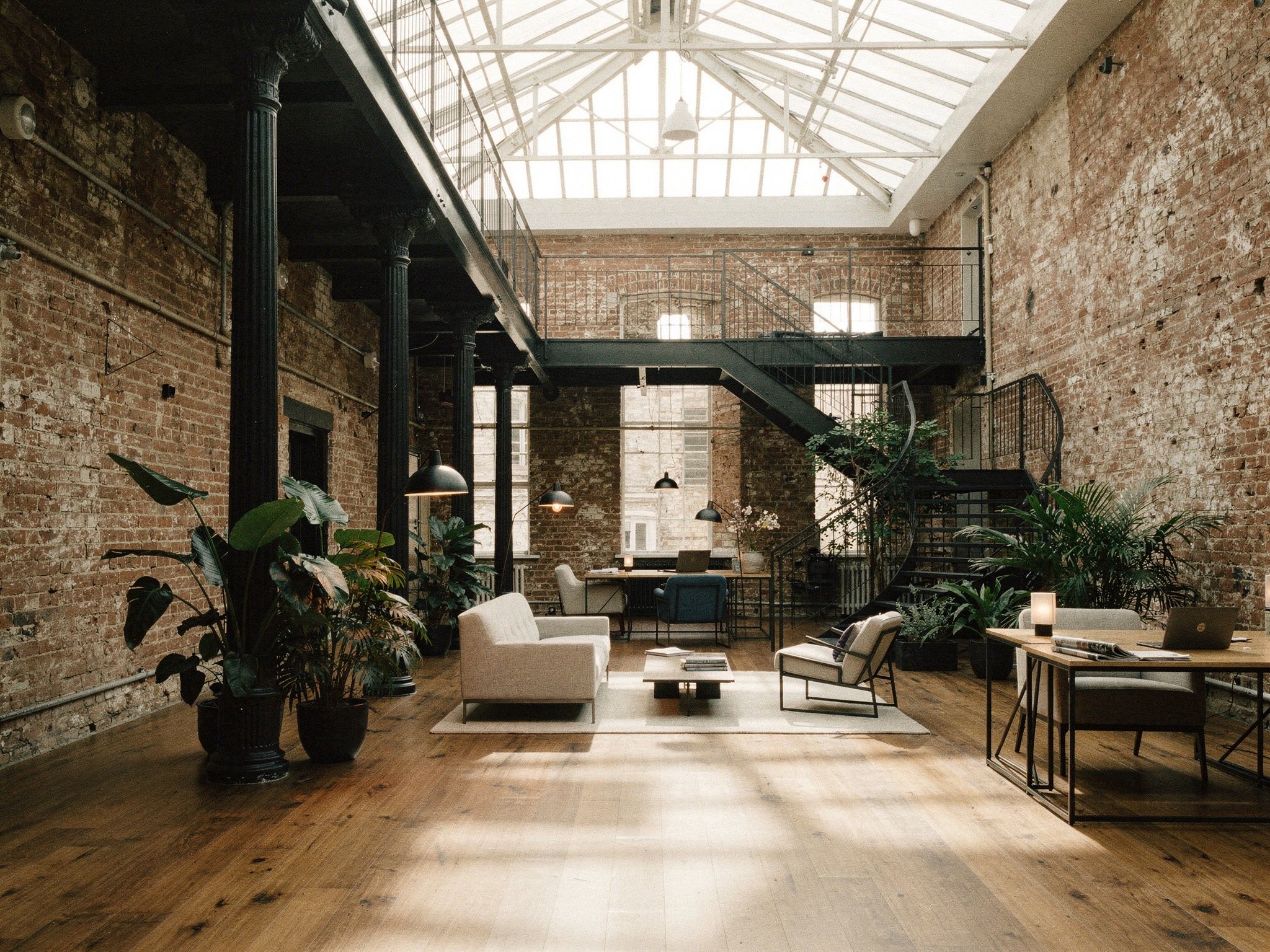 A top-lit atrium with brick walls, cast-iron columns and a steel mezzanine