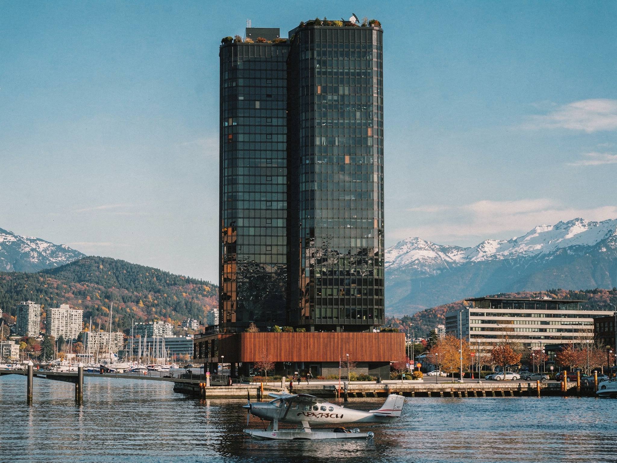 Harbour Quarter Tower — black-glass waterfront office tower on a mahogany podium