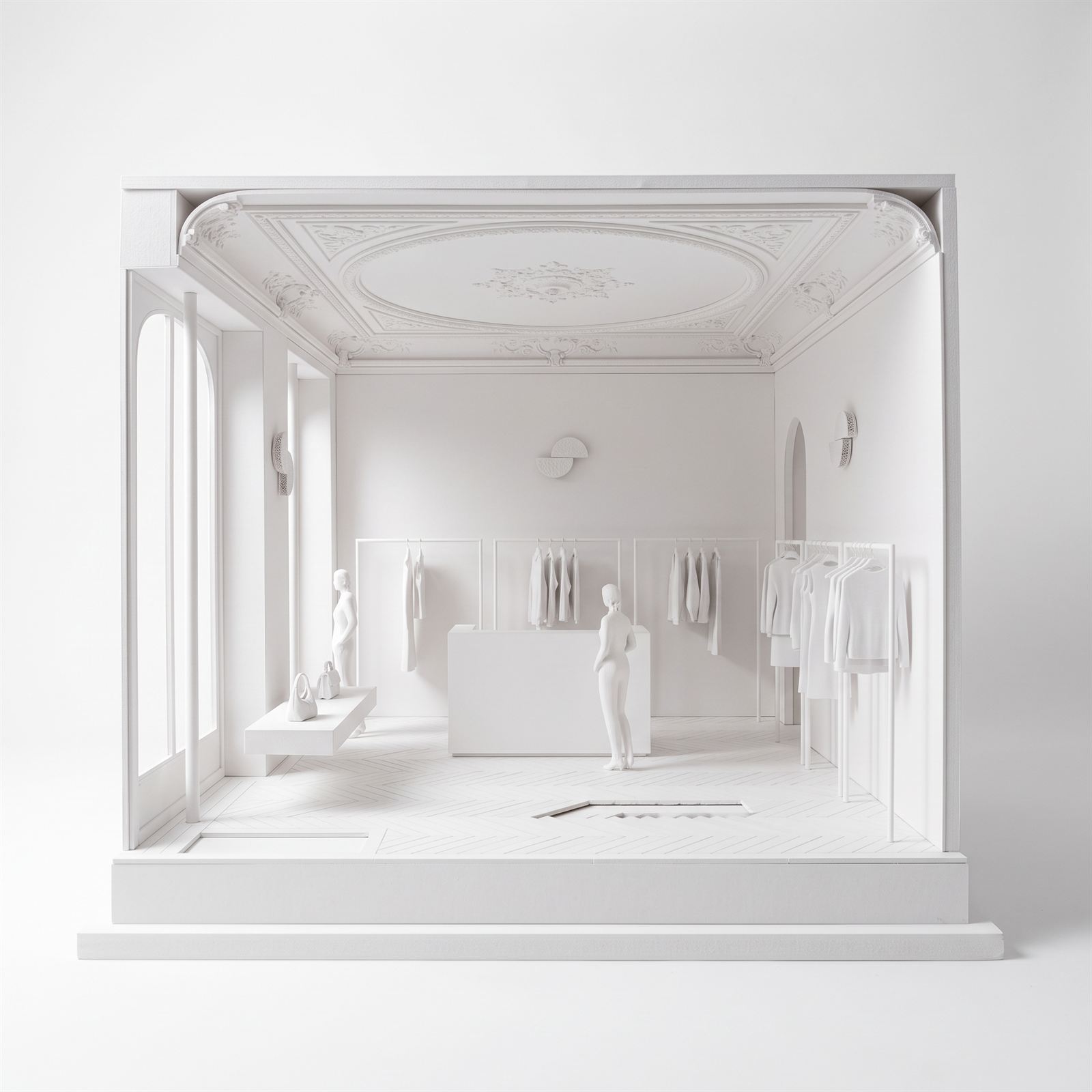 White card model of the salon photographed straight on, with figures, rails and the ceiling rose