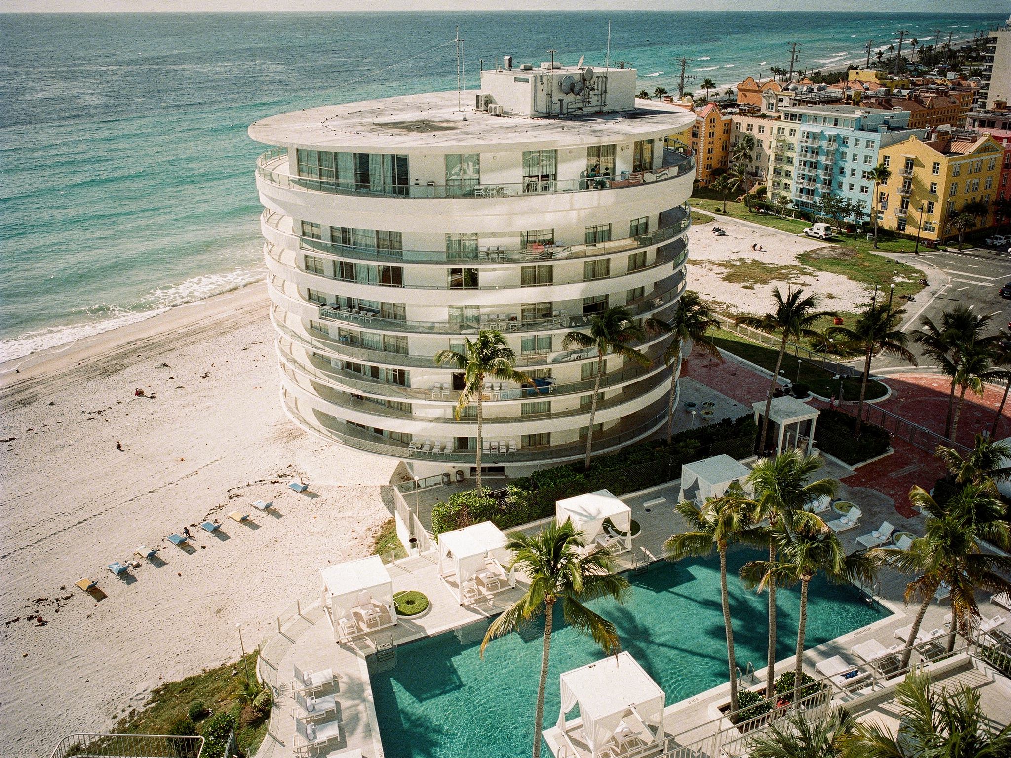 Aerial along Miami Beach with the hotel mid-frame in bright morning light