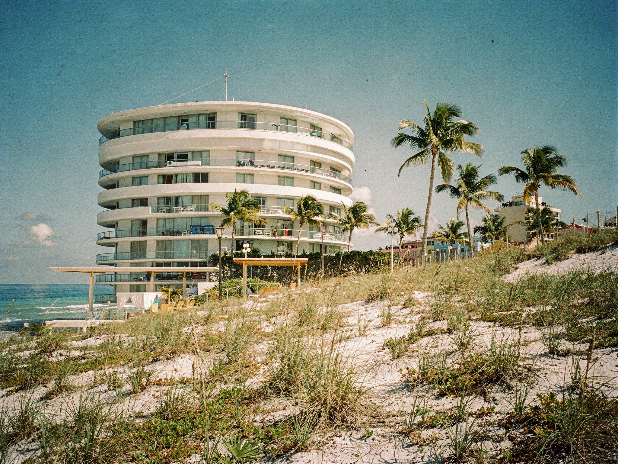 The tower from the dunes past a couple on the boardwalk