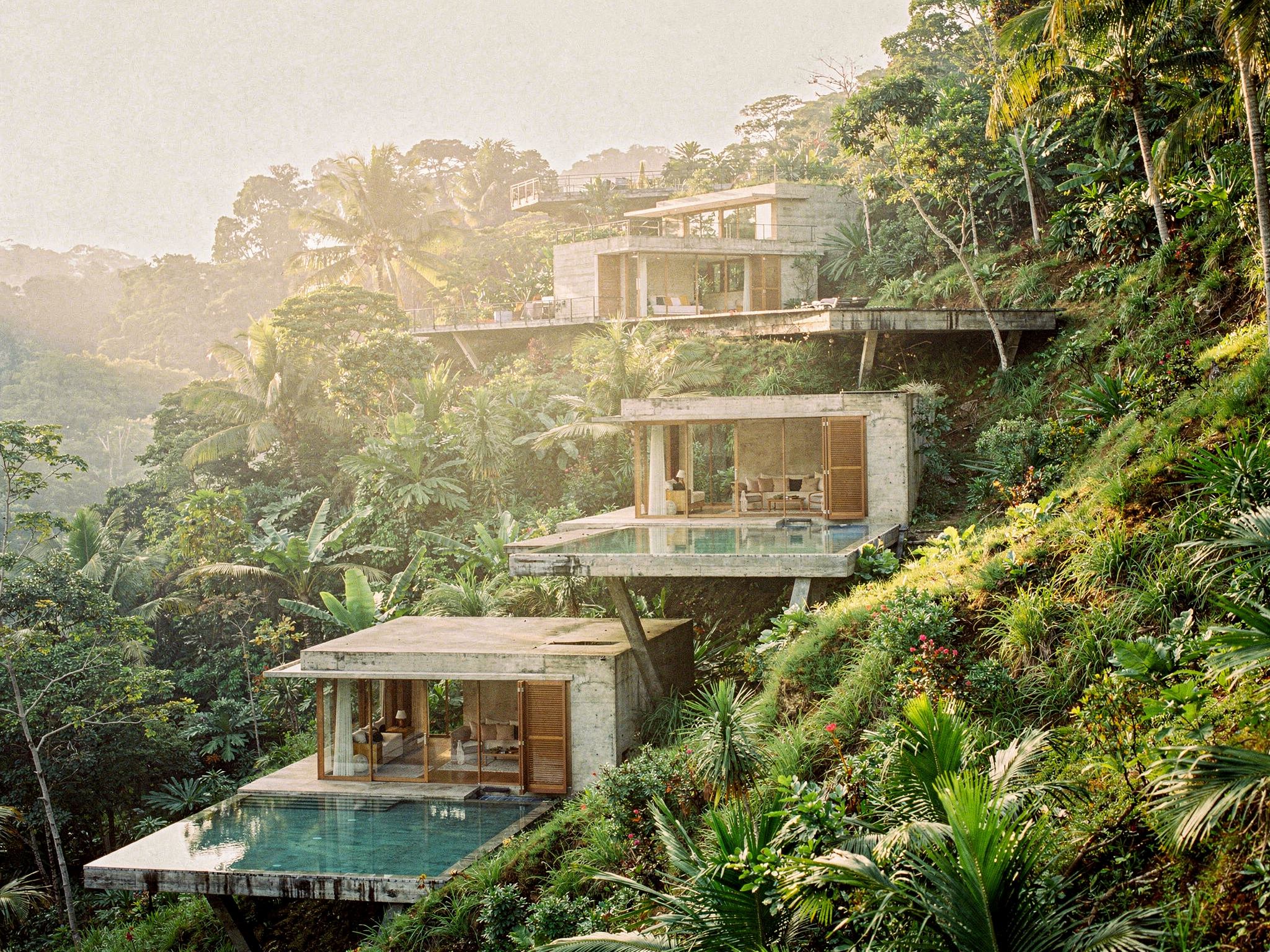 Concrete pavilions with lap pools cascading down the jungle slope