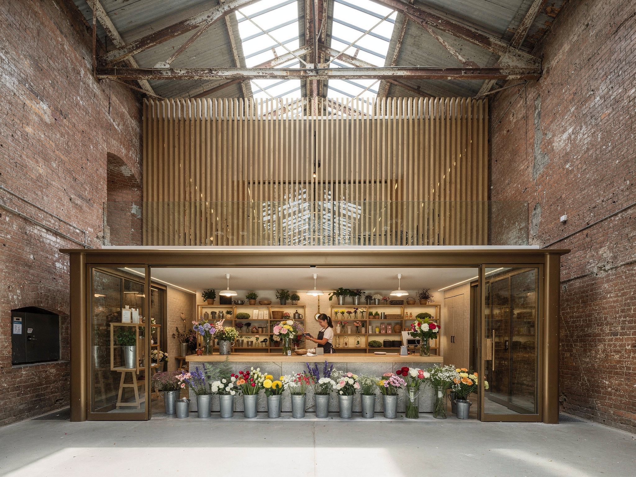 Boutique florist with a zinc bench opening to the cobbled lane through a steel shopfront