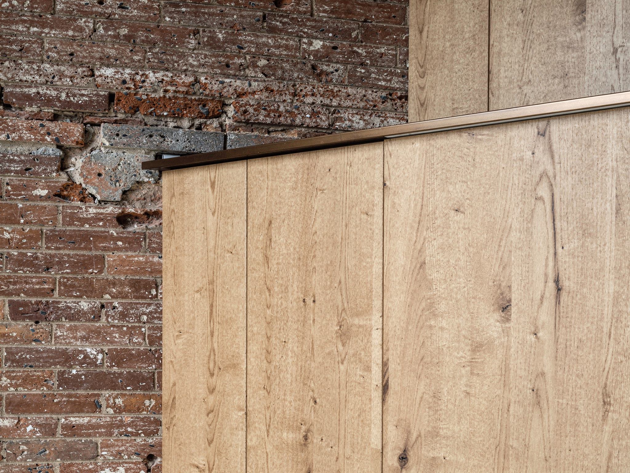 Detail of the new steel column on its base plate bolted clear of the original brickwork