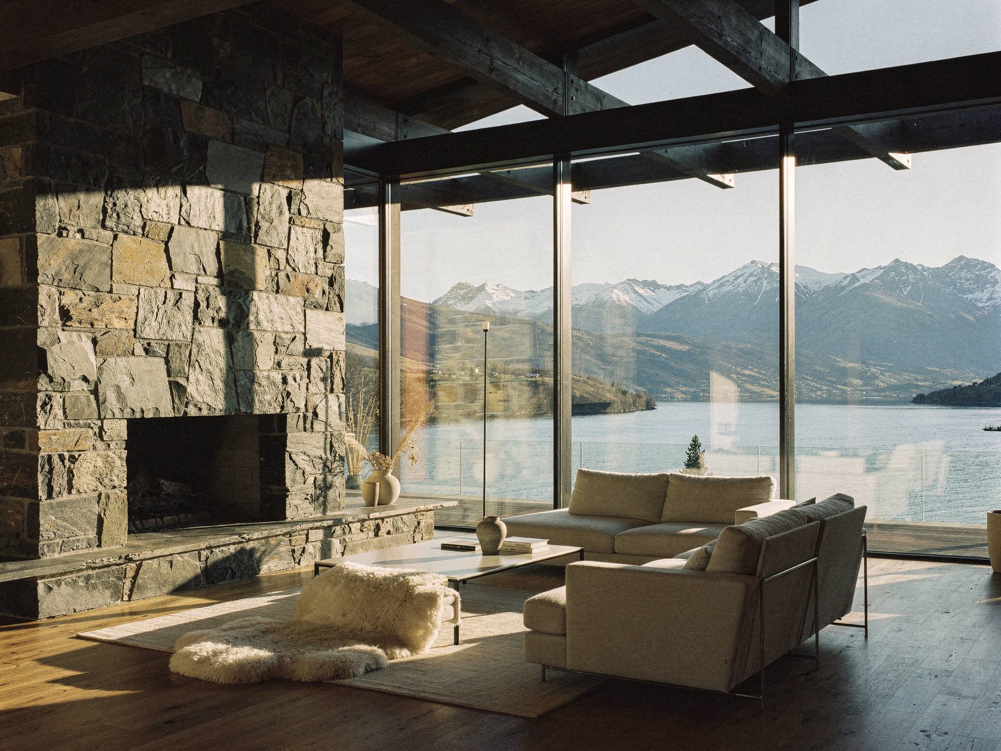 Living room with schist hearth and full-height glass to the lake