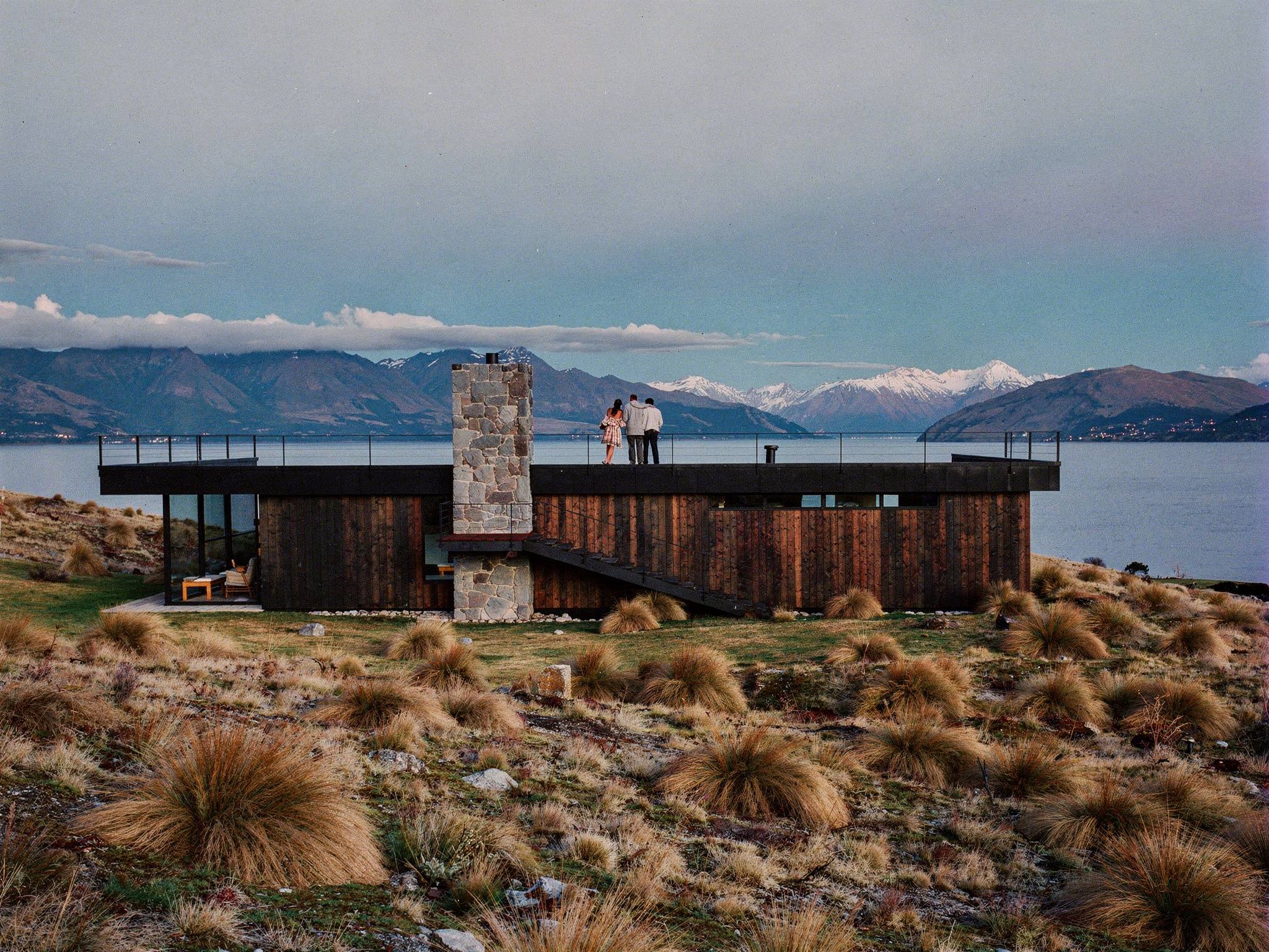 Family on the rooftop deck at dusk looking to the Southern Alps